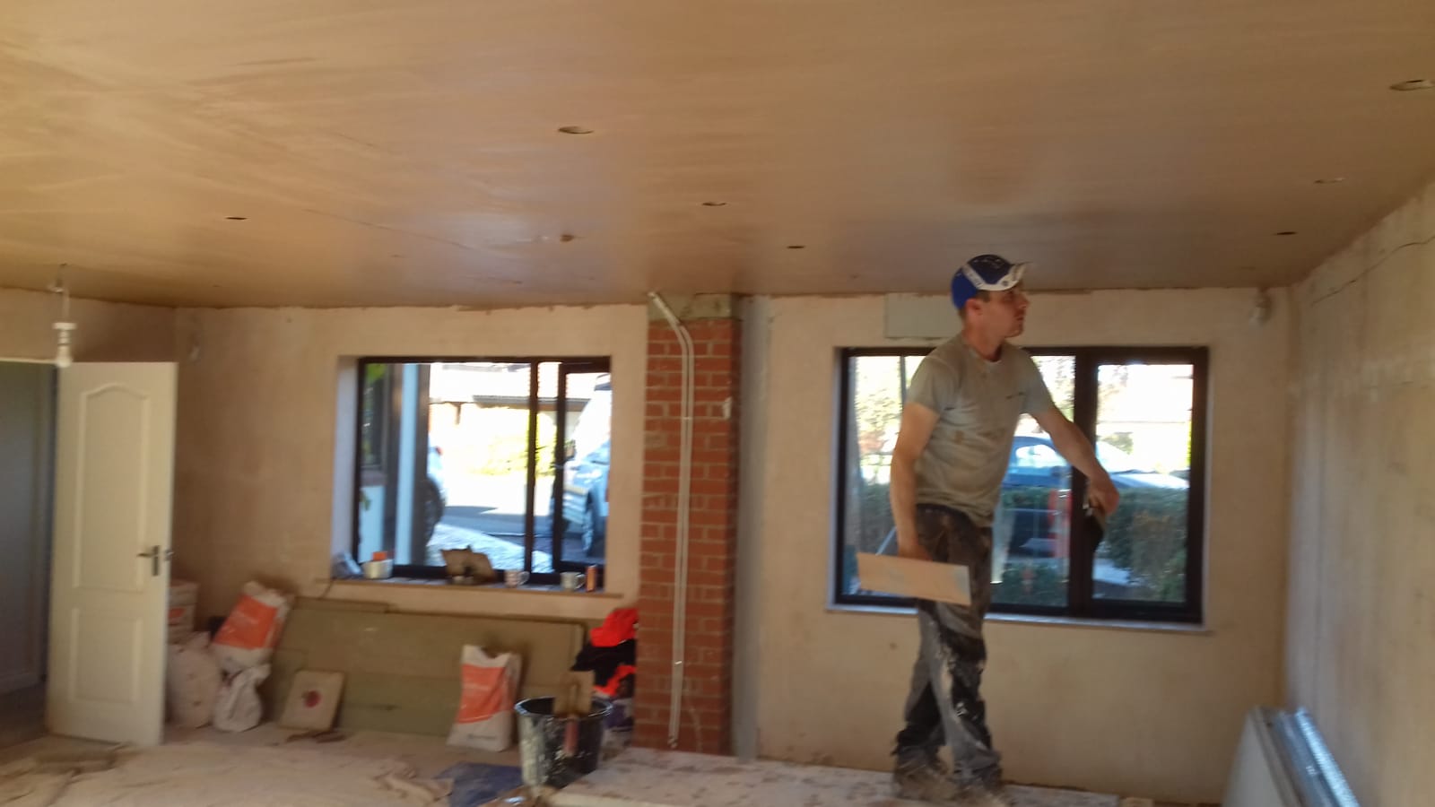 Terry skimming a freshly plastered ceiling on a Redcar job